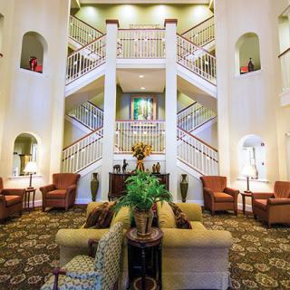 A well-decorated lobby with symmetrical stairs and comfortable seating arrangements.