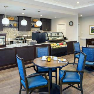 A modern cafe interior with a seating area and service counter.