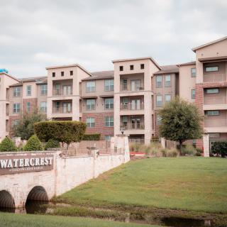 A view of a modern apartment complex with landscaped surroundings.
