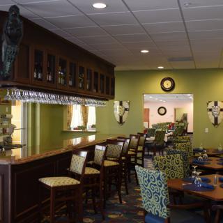 A cozy bar and restaurant interior with wooden furniture and vibrant decor.