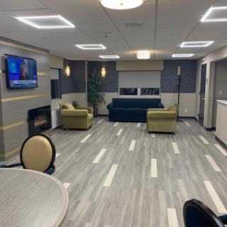 A modern lounge area featuring comfortable seating, a television, and contemporary design elements.