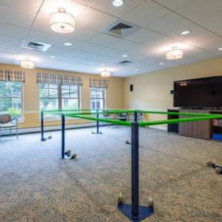A therapy room featuring parallel bars for rehabilitation exercises.