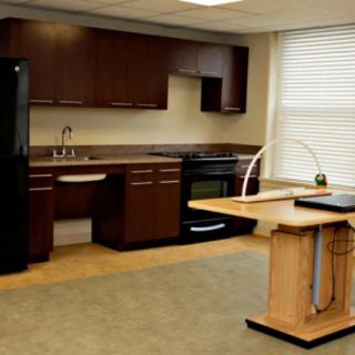 A modern kitchen featuring dark wood cabinets, an island counter, and essential appliances.