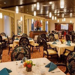 An elegant restaurant interior with neatly arranged tables and chairs.