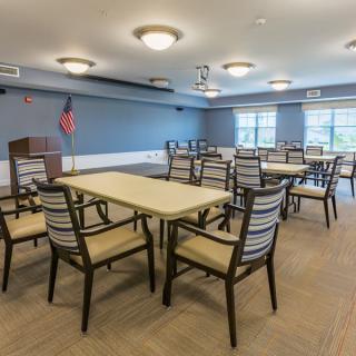 A spacious conference room with tables and chairs arranged for a meeting.
