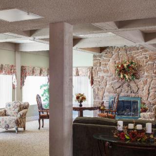 A cozy living room with elegant decor and a stone fireplace.
