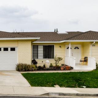 A single-story suburban house with a well-maintained lawn and driveway.