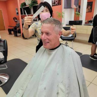 A man getting a haircut in a barbershop.