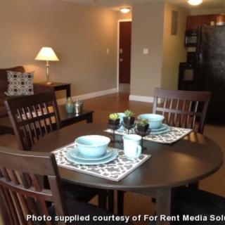 A cozy dining area in a modern apartment with place settings on the table.