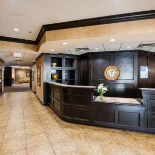 A welcoming reception area with a polished front desk and tiled flooring.