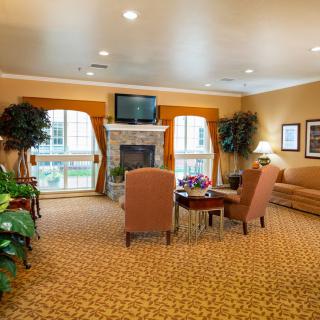 A cozy living room with comfortable seating, a fireplace, and a television.