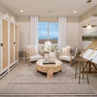 A beautifully designed living room featuring neutral tones, comfortable seating, and a blend of modern decor elements.
