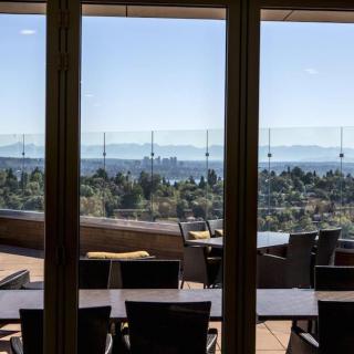 A scenic outdoor patio with tables and chairs overlooking a beautiful landscape.