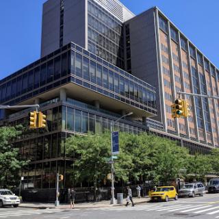 A modern urban building showcasing contemporary architecture against a clear blue sky.