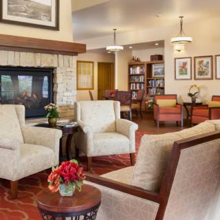 A cozy living room with comfortable seating and a fireplace.