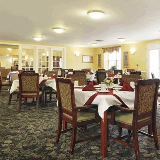 An elegant dining room with neatly arranged tables and chairs.