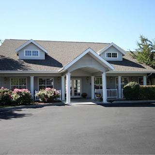 A suburban house with a covered entrance and landscaped surroundings.