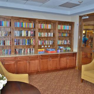 A cozy reading nook featuring a well-stocked bookshelf and comfortable seating.