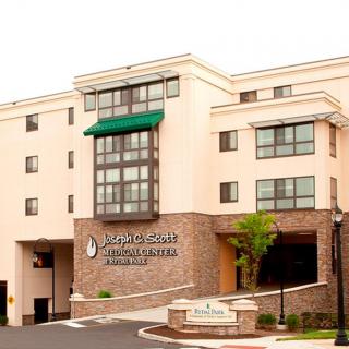 A modern hospital building with a prominent entrance.