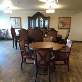 A dining room with wooden furniture and a classic interior design.