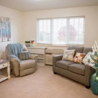 A cozy living room with comfortable seating and natural lighting.