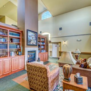 A cozy living room with bookshelves and a fireplace.