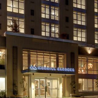 Illuminated entrance of a hotel building at night.