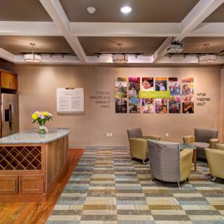 A cozy and welcoming lobby area with comfortable seating, decorative elements, and a reception desk.