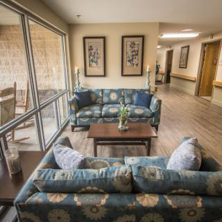 A cozy living room area featuring comfortable sofas and a coffee table, designed for relaxation and social interaction.