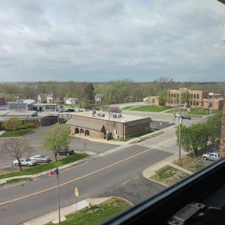 A view of the city featuring a street scene with buildings and a cloudy sky.