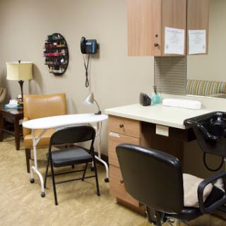An interior view of a medical office featuring seating and healthcare equipment.