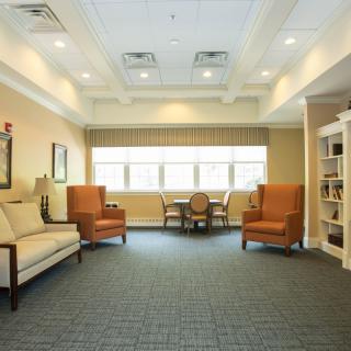 A cozy lounge area with comfortable seating and natural lighting.