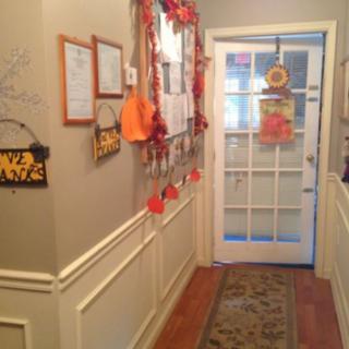 A hallway decorated with festive Halloween and autumn-themed decorations.