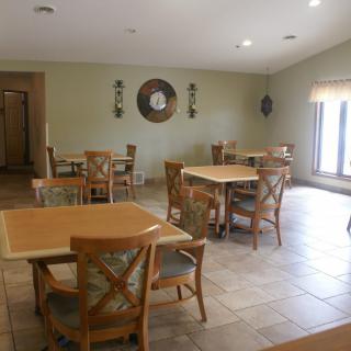 A cozy dining area with multiple tables and chairs arranged neatly.