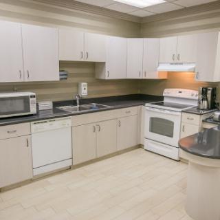 A modern kitchen featuring essential appliances and ample storage.