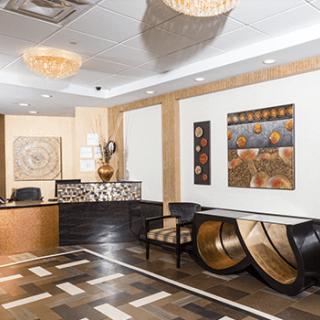 A modern reception area with elegant furnishings and artwork on the walls.