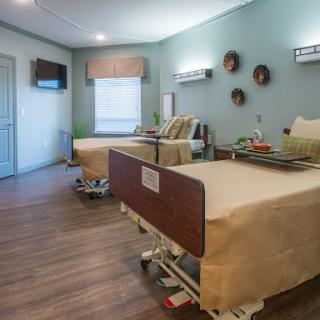 A modern hospital patient room equipped with comfortable beds and a welcoming atmosphere.