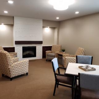 A comfortable living room space featuring a fireplace and cozy seating arrangements.