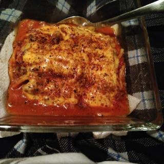 A delicious serving of homemade lasagna, baked to perfection.