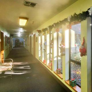 Sunlit hallway with festive decorations and seating.