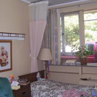 A cozy and well-decorated bedroom with a view.