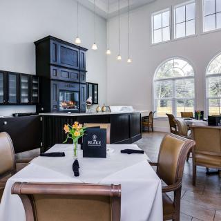 A modern restaurant dining area with elegant tables and natural lighting.