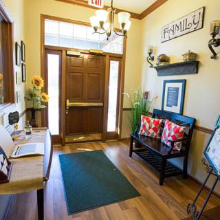 A cozy and inviting entryway with warm decor and wooden flooring.