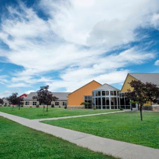 A vibrant campus scene featuring modern architecture and a clear blue sky.