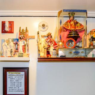 A home altar adorned with various religious statues and icons.