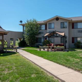 A two-story building with a gazebo and well-maintained lawn.