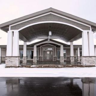 A building entrance with arched roofs and snow-covered ground.