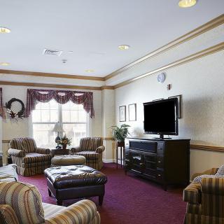 Comfortable living room with cozy seating and a TV.