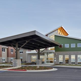 A modern commercial building with a prominent entrance.