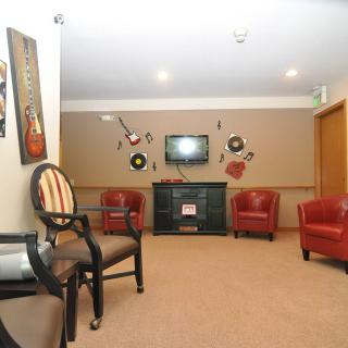 A cozy living room with music-themed decor and comfortable seating.